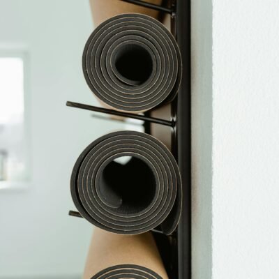 An artistic view of stacked yoga mats in a modern minimalist indoor space.